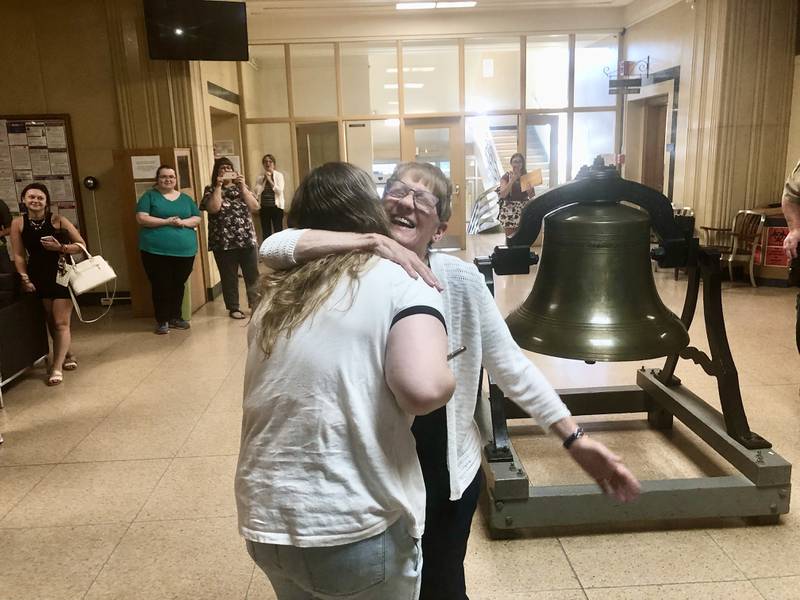 Deb Landrus, who is retiring after 45 years working in the Bureau County Clerk's office, gets a hug from her grand daughter, Chloe Landrus Thursday in the courthouse lobby, She is the longest tenured employer in courthouse history.