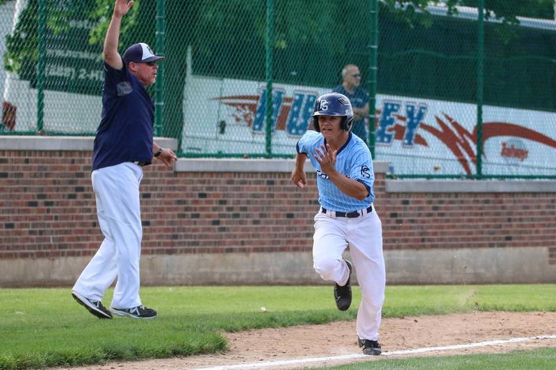 Plainfield South head coach Phil Bodine (left) waves his player home during a game.