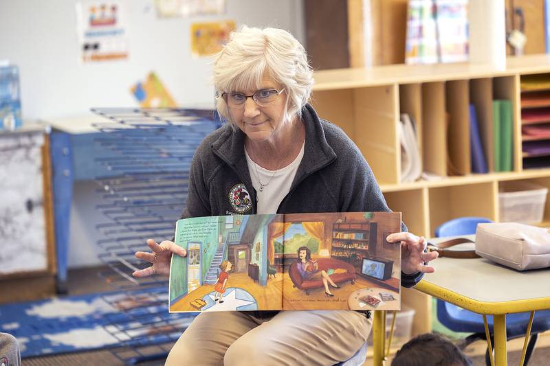Stacy Flanagan, Chief of Staff for State Rep. Brad Fritts, reads a book Thursday, Jan. 23, 2025, to students in the Wallace School TCOC Head Start program.