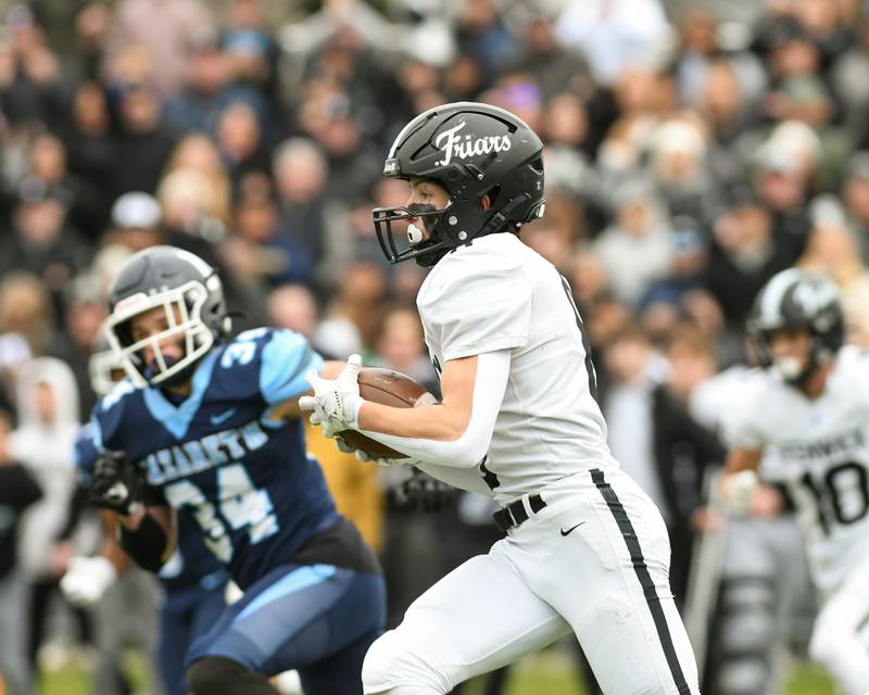 Fenwick's Jake Thies (8) runs the ball for a first down before being brought down by Nazareth Academy defenders on Saturday Nov. 22, 2025, during the game held at Nazareth Academy High School in La Grange Park.