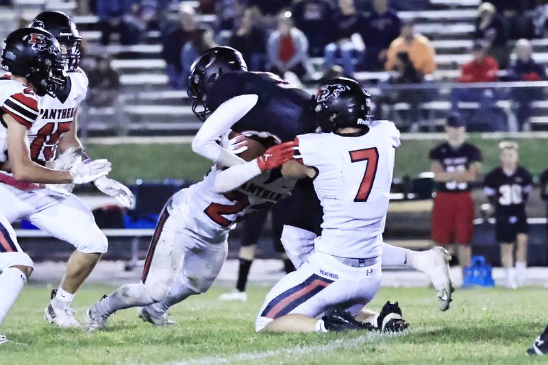 Orion Chargers senior running back #33 Griffin Tennant's progress is halted by EP Panthers #7 Gaven Adams and  # 22 Tristan Hovey Friday, Oct. 10, 2025, in Orion.