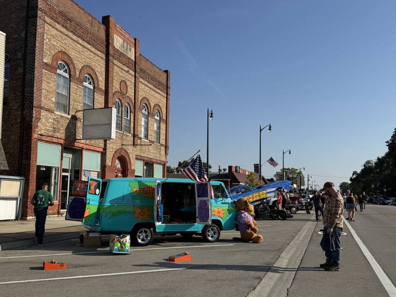 Passersby check out a Mystery Machine during the car show at Coal City Fall Fest on Saturday, Sept. 13, 2025.