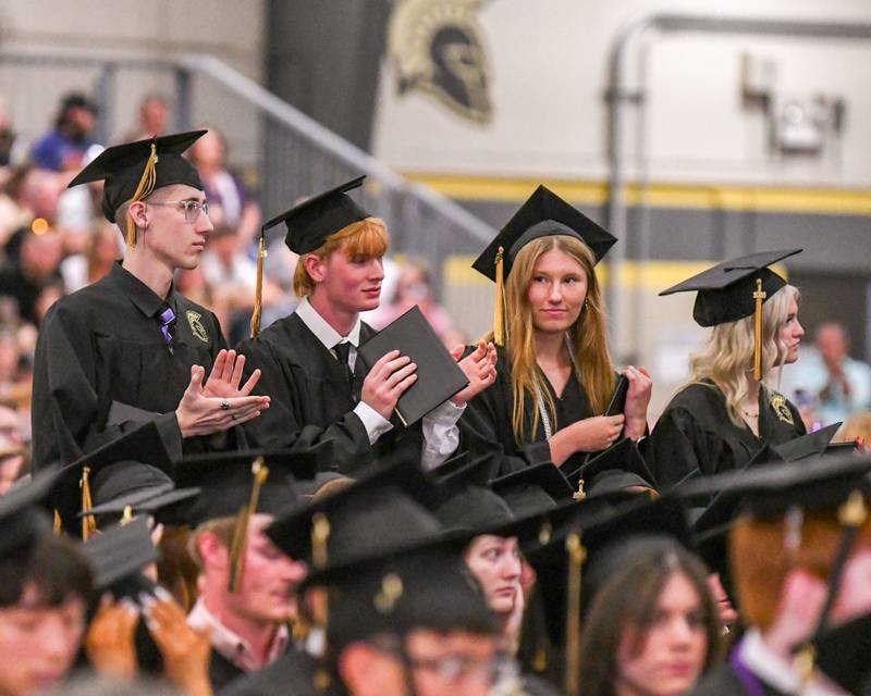 Sycamore graduates clap for their classmates as they receive their diplomas on Sunday May 24, 2026, during the graduation ceremony held at Sycamore High School.