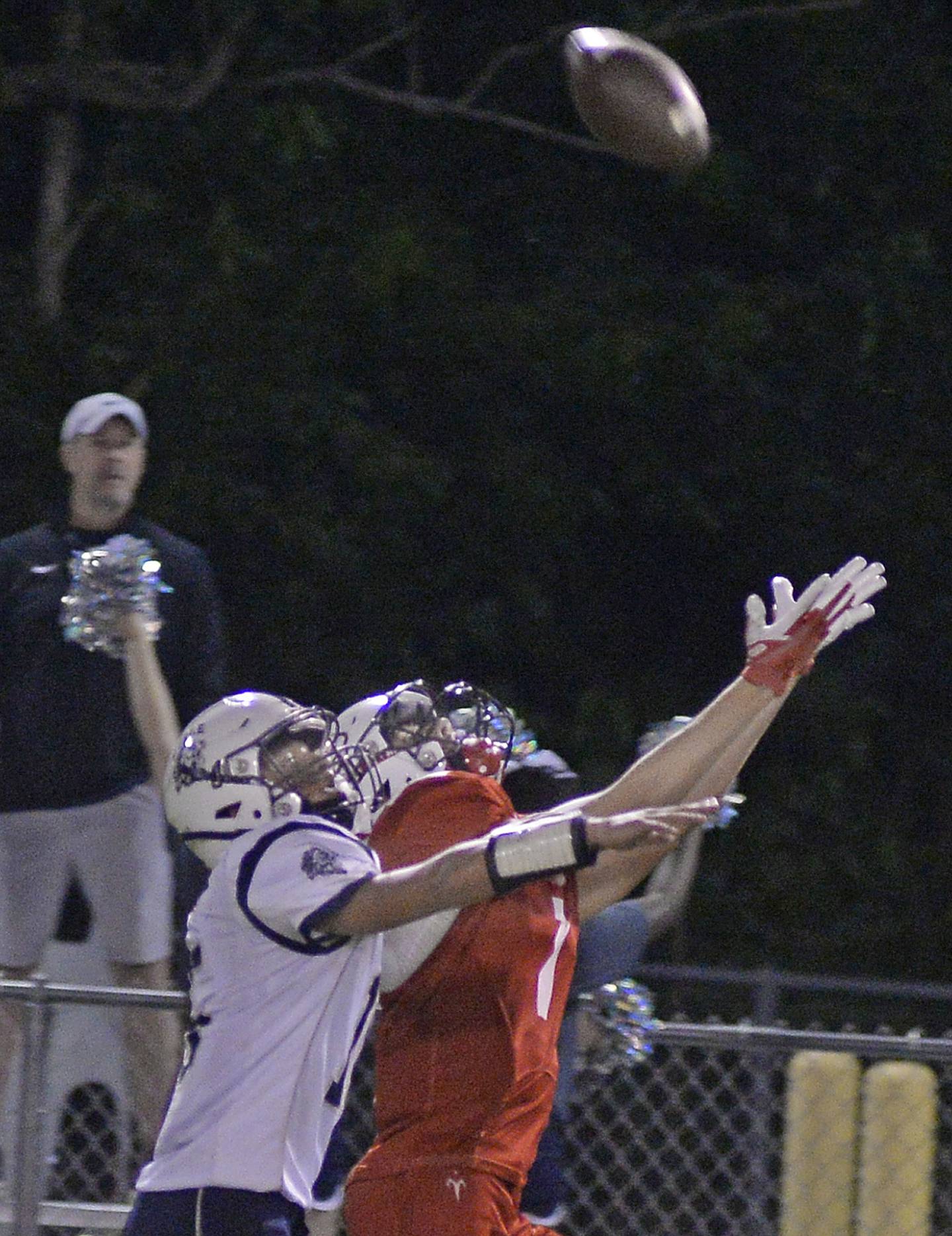 Lisle's Casey Rosenberg (15)_ and Streator’s Matt Williamson (7) reach for a pass Friday, Sept. 16, 2022, at Doug Dieken Stadium in Streator.