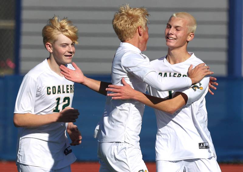 Coal City players celebrate a goal by Dylan Fatlan (right) Friday, Nov. 7, 2025, during their Class 1A state third place game against Chicago Academy at Hoffman Estates High School.