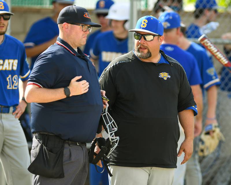 Somonauk’s coach talks with the home plate umpire between innings after two balks were called against his pitcher during the same inning on Tuesday May 13, 2025, while taking on Newark high School.