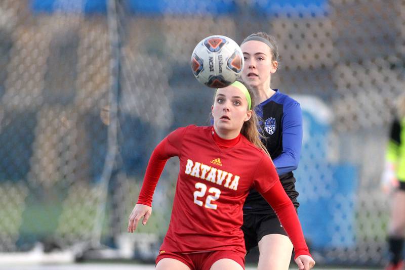 Batavia’s Ryan Gianfrancesco keeps her eyes on the ball ahead of Geneva’s Morgan Slagle during a Tri-Cities Night game at Geneva High School on Tuesday, April 26, 2022.
