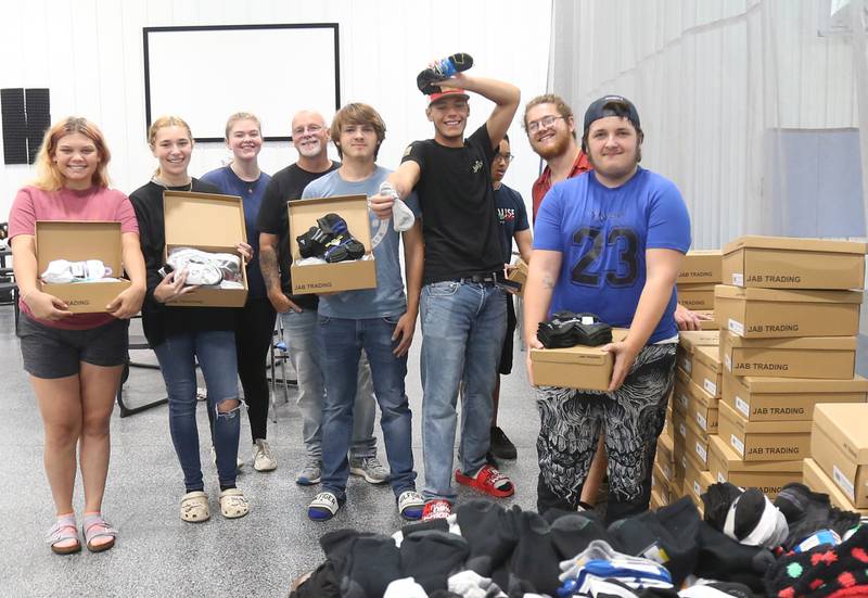 Jeff Van Autreve, (fourth from left) founder of Second Story Teen Center, poses with volunteers and clients during the Shoes and Socks Giveaway on Saturday, Aug. 2, 2025 at the Second Story Teen Center in Princeton. The drive collected 1,250 socks and 420 pairs of shoes from size 4-14 for kids. Half of the donations came from Another Child Foundation and Christ Community Church in Princeton. The other remaining supplies were donated from people in the community.