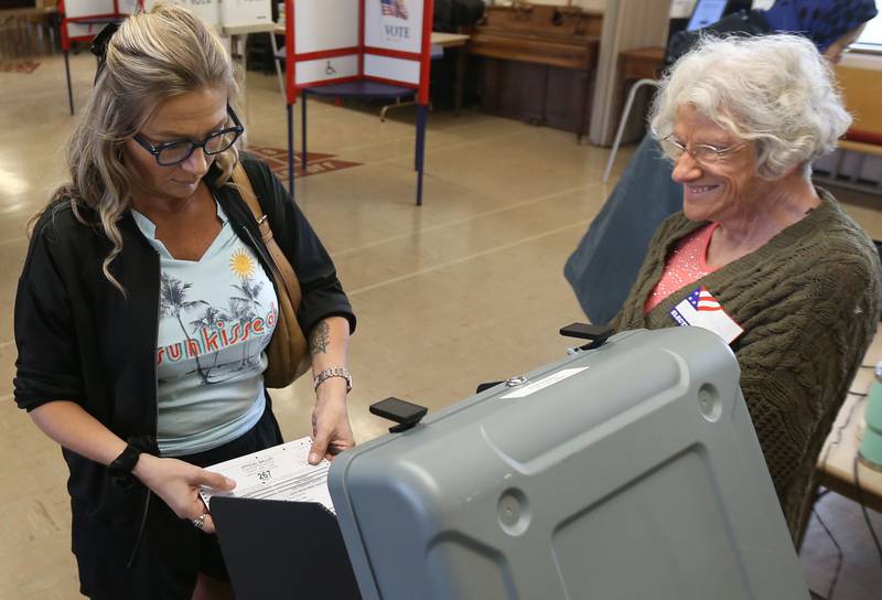 Michele Fusinatto casts her ballot with the help of Election judge Toma Newburn on Tuesday, April 1, 2025 at St. Johns Lutheran Church in Peru.