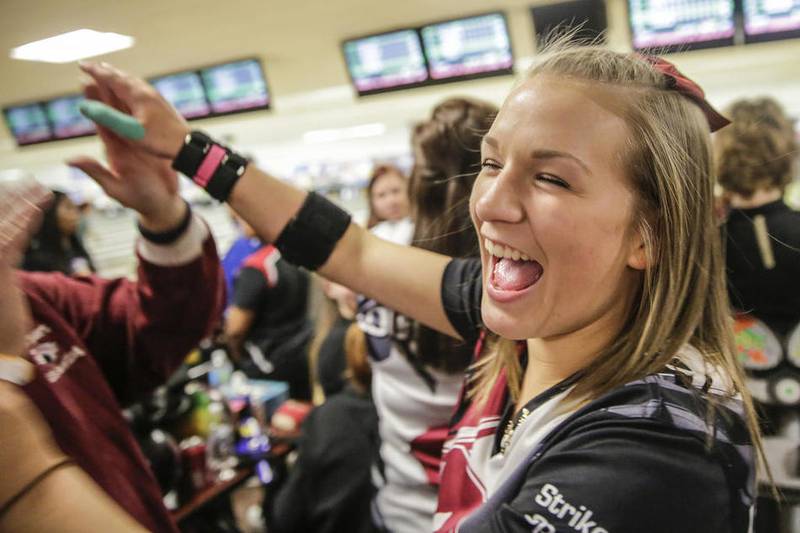 Lockport’s Dana Ackerson high-fives her teammates during last year's Joliet West Sectional at Town and Country Lanes, which the Porters won en route to a third-place state finish. On Saturday at Cherry Bowl in Rockford, Ackerson finished sixth individually to help the Porters finish second and claim their third straight state trophy.