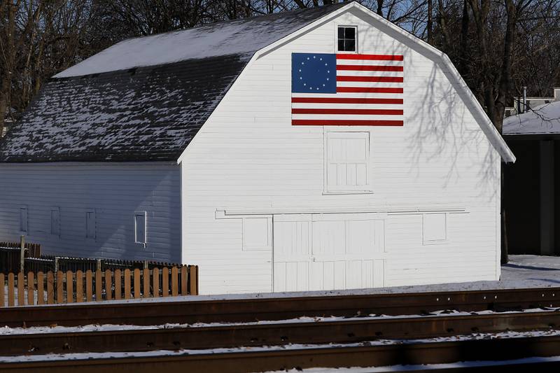 The sun lights up the “Betsy Ross American Flag” on the side white barn on Thursday, Jan. 23. 2025, in Crystal Lake.