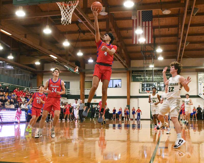 Glenbard South's Masroor Sahi (4) makes a basket during the first quarter Monday Nov. 20, 2023, while getting past Glenbard West's Bennett Schwnanke (22) during The district 87 Invite held at Glenbard West.