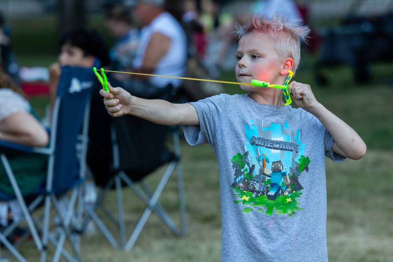 Theodore Delk plays with slingshot on Saturday, July 5, 2025 at Carey Memorial Park in Utica.