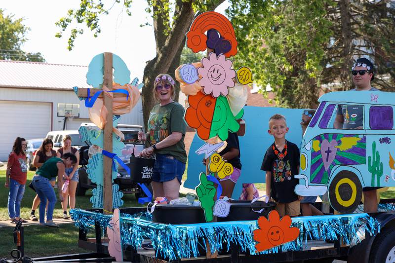 Parade participants from Real Life Church ride on their float in the Grand Pumpkin Parade during the St. Anne Pumpkin Festival on Saturday, Oct. 4, 2025.