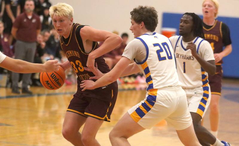 Richmond-Burton’s Luke Robinson moves the ball  in varsity boys basketball onTuesday, Dec. 9, 2025, at Johnsburg High School in Johnsburg.