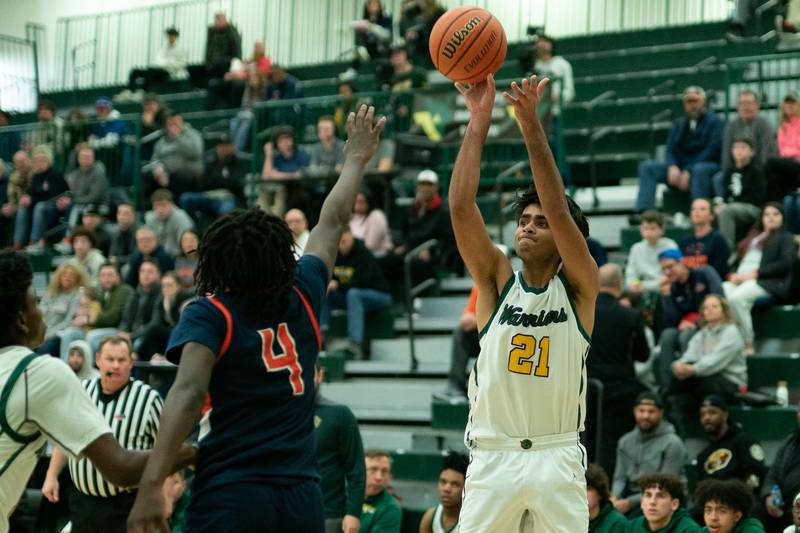 Waubonsie Valley's Shoi Rathi (21) shoots the ball on the wing against Oswego’s Jayden Riley (4) during a Waubonsie Valley 4A regional semifinal basketball game at Waubonsie Valley High School in St.Charles on Wednesday, Feb 22, 2023.