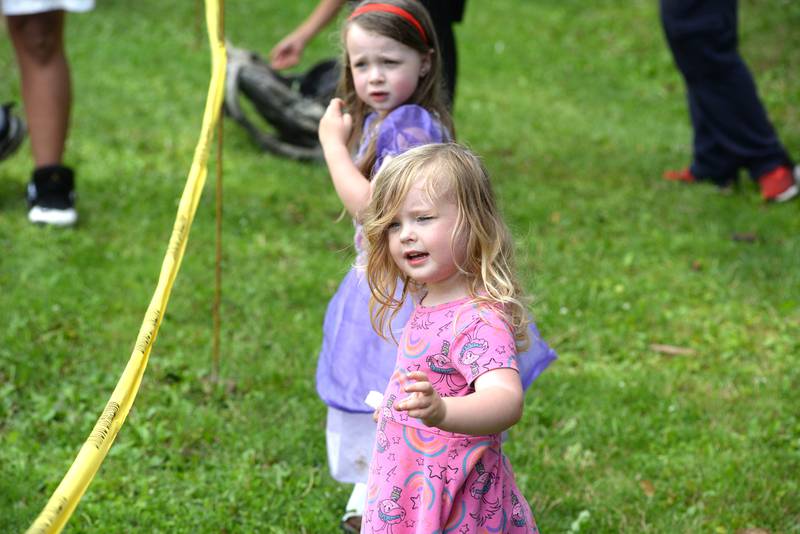 Nora, 3, and Lucy, 4, wave to an entry in the German Valley Days parade on Saturday, July 19, 2025. The girls snagged a lot of candy as they watched the parade with their mom Rebecca.