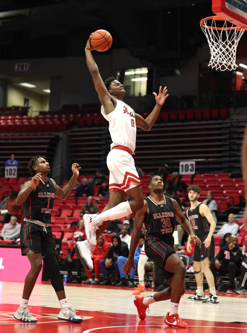 Northern Illinois' Xavier Amos dunks in front of two Illinois Tech defenders during their game Monday, Nov. 13, 2023, at the NIU Convocation Center in DeKalb.