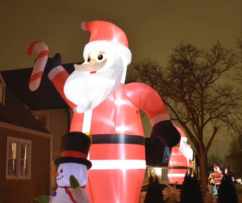 More than 30 huge inflatable Santa Claus figures are on display in a seven-block stretch of Ashland Avenue in La Grange and Countryside.(