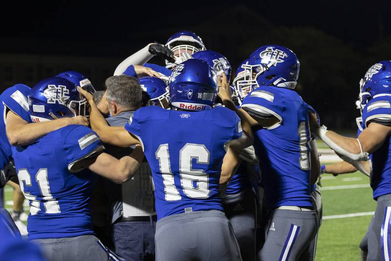 Newman players and coaches celebrate a OT win against Rockridge Friday, Sept. 27, 2024, in Sterling.