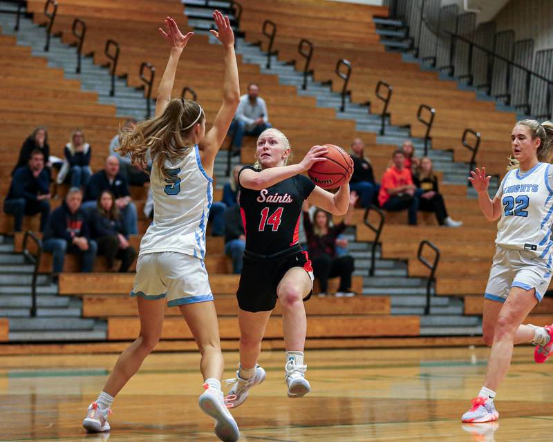 St Charles East's Addie Schilb (14) eurosteps to the basket at the York Thanksgiving Tournament. Nov 13, 2023.