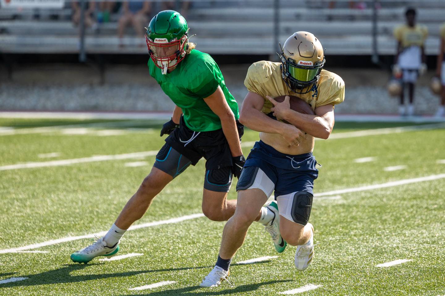 Jaxsen Higgins of Marquette tucks ball as Mason Morscheiser of L-P chases during scrimmage on Tuesday July 16, 2025 at Howard Fellows Stadium in LaSalle.