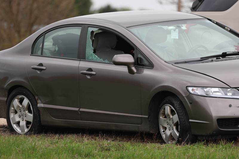 A Honda sedan with a shattered window sits in the westbound lanes of Interstate 88 Monday, April 27, 2026, as police investigate an incident on I-88 just west of Keslinger Road in Maple Park.