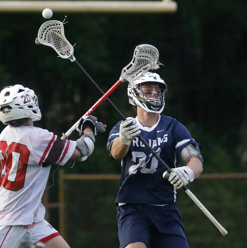Cary-Grove's Quintin Witt throws the ball as Huntley's Cameron Abordo defends during the Marian Central Sectional boys lacrosse semifinal match on Wednesday, May 28, 2025, at Marian Central High School in Woodstock.