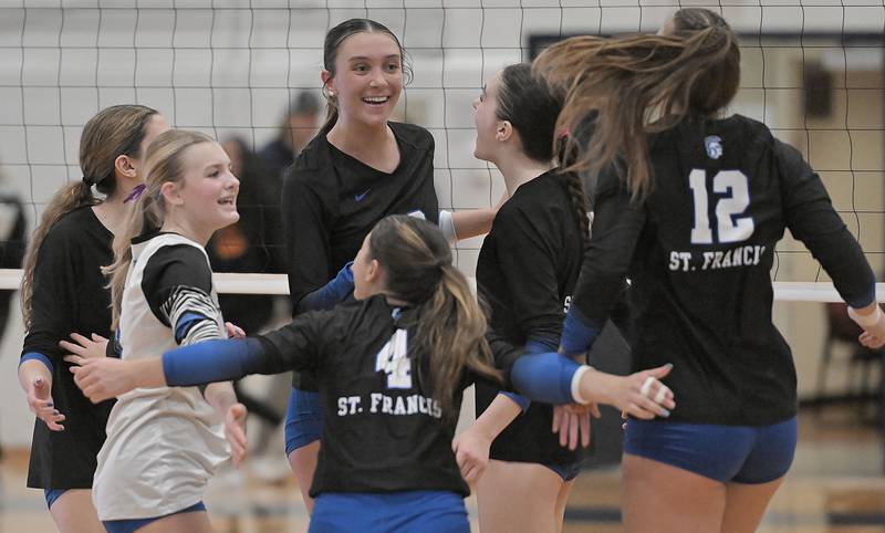St. Francis celebrates a point against Wheaton Academy in an IHSA Class 3A sectional final girls volleyball match in Arlington Heights on Thursday, Nov. 7, 2024.