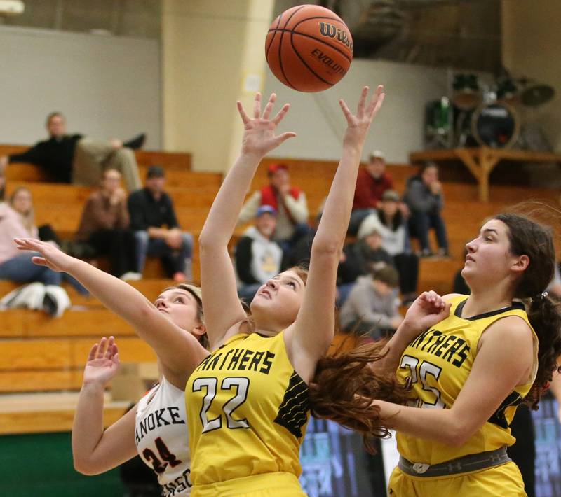 Putnam County's Maggie Sprat (center) grabs a rebound over Roanoke Benson's Maggie Luginbuhl during the Tri-County Conference Tournament on Tuesday, Jan. 17, 2023 at Midland High School.