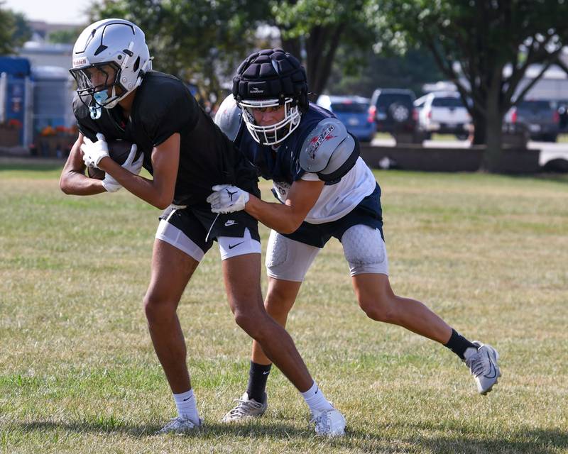 Evan Frieders, right, hangs on to the ball while being defended by Mariano Velasco of Kaneland during a joint practice on Thursday July 10, 2025, held at Oswego High School.
