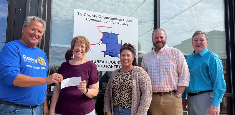 (From left) Joe Park (Princeton Rotary Club president), Vanessa Hoffeditz (Bureau County Food Pantry director), Jen Conwell (manager at The Princeton Closet), TJ Scruggs (Country Financial representative), and Chris Neahring (Bureau County United Way executive director) pass a check of $3,600 to the Bureau County Food Pantry.