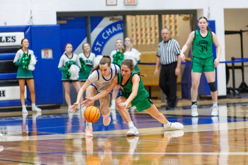 St. Charles North's Jillian Salter battles for the loose ball with York's Ellie Kehoe at the Class 4A Regional Final on Thursday, Feb.19,2026 in St. Charles.
