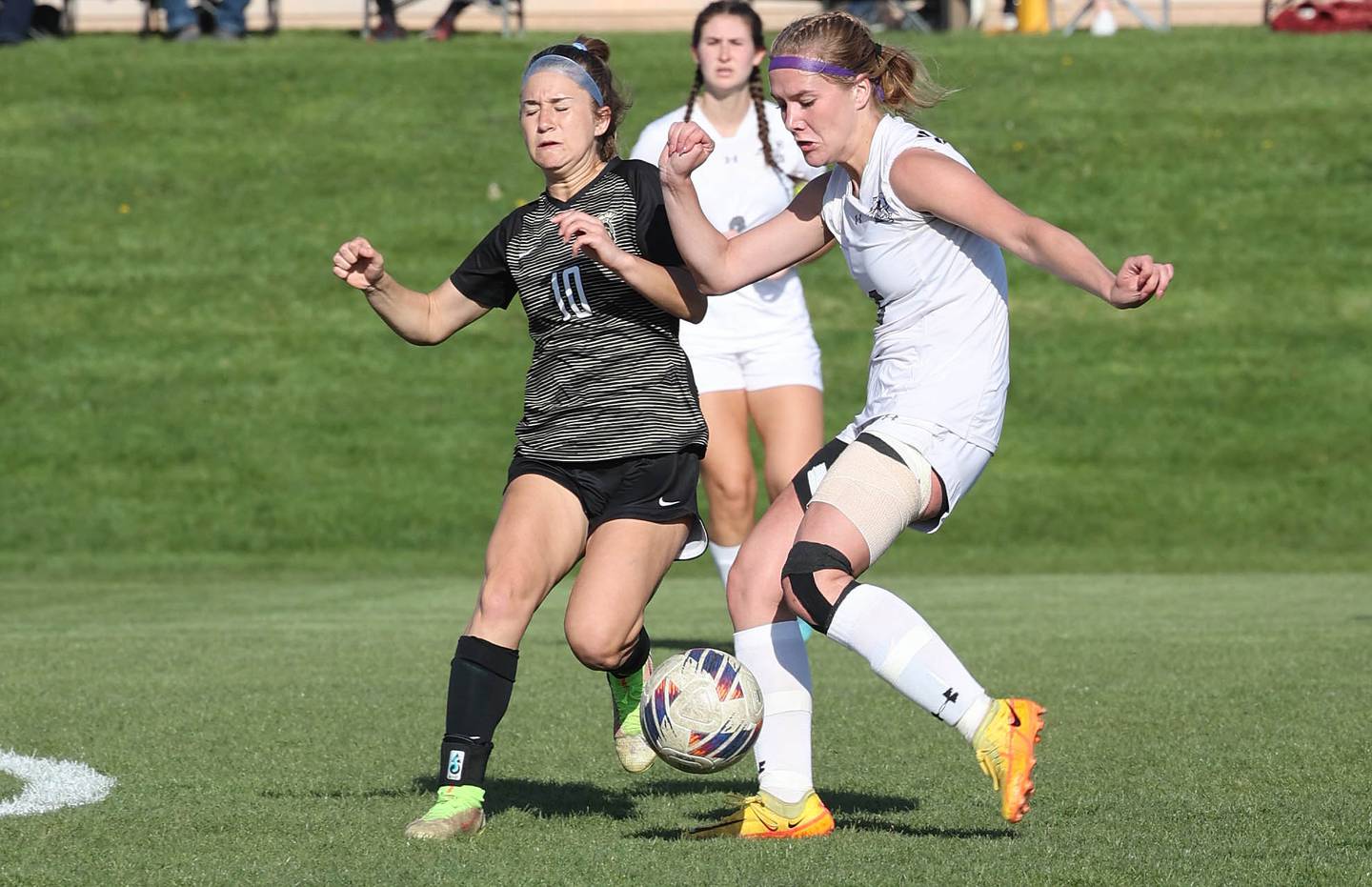 Sycamore's Faith Schroeder (left) and Kaneland's Brigid Gannon go after the ball Friday, April 28, 2023, during their game at Sycamore High School.
