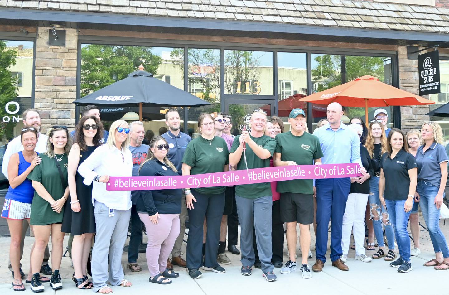 Quickie Subs owner Nick Ross gets ready to cut the ribbon next to his husband and owner Mark Ross during the ceremony held at 4 p.m. Wednesday June 14.