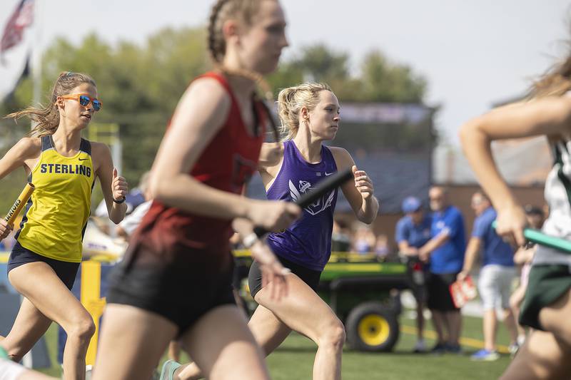 Dixon’s Hannah Steinmeyer takes the first leg of the state qualifying 4x800 Thursday, May 11, 2023 at the class 2A Sterling girls track sectionals.