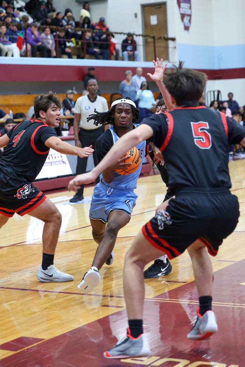 Kankakee's Cedric Terrell III evades defenders on an approach during the Kays' 54-50 victory over Lincoln-Way Central in the 75th Kankakee Holiday Tournament maroon bracket championship on Sunday, Dec. 28, 2025.