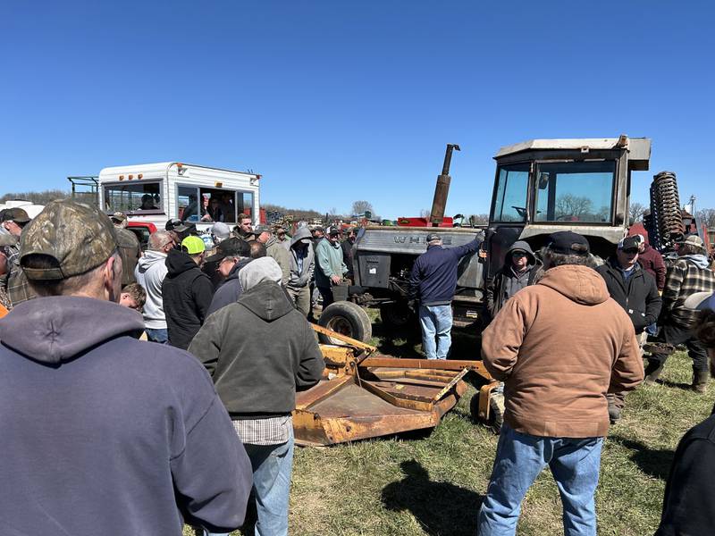 An auctioneer takes bids on a tractor at the Hazelhurst Annual Spring Consignment Auction Saturday, April 6, 2024. The annual event is held each year on a farm along Milledgeville Road, between Polo and Milledgeville.