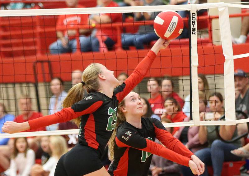 L-P's Addison Urbanski saves the ball with help from teammate Katie Sowers on Thursday, Sept. 21, 2023 at Kingman Gym.