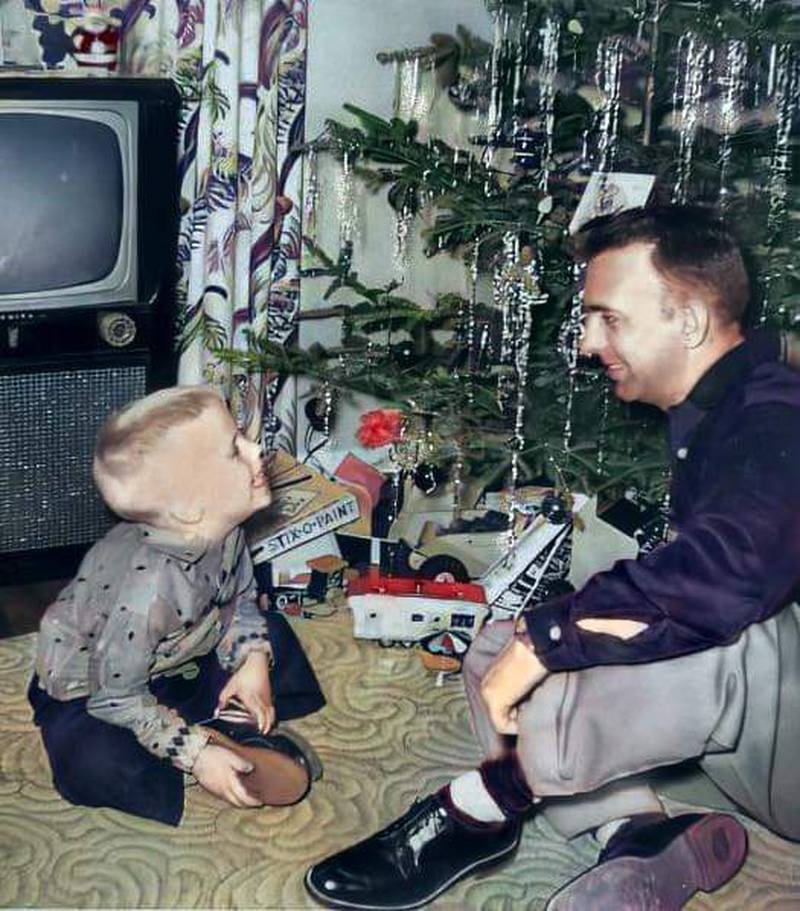 Gary Corlew of Joliet enjoys a special moment with his father Elvin Corlew on Christmas Eve, 1955.