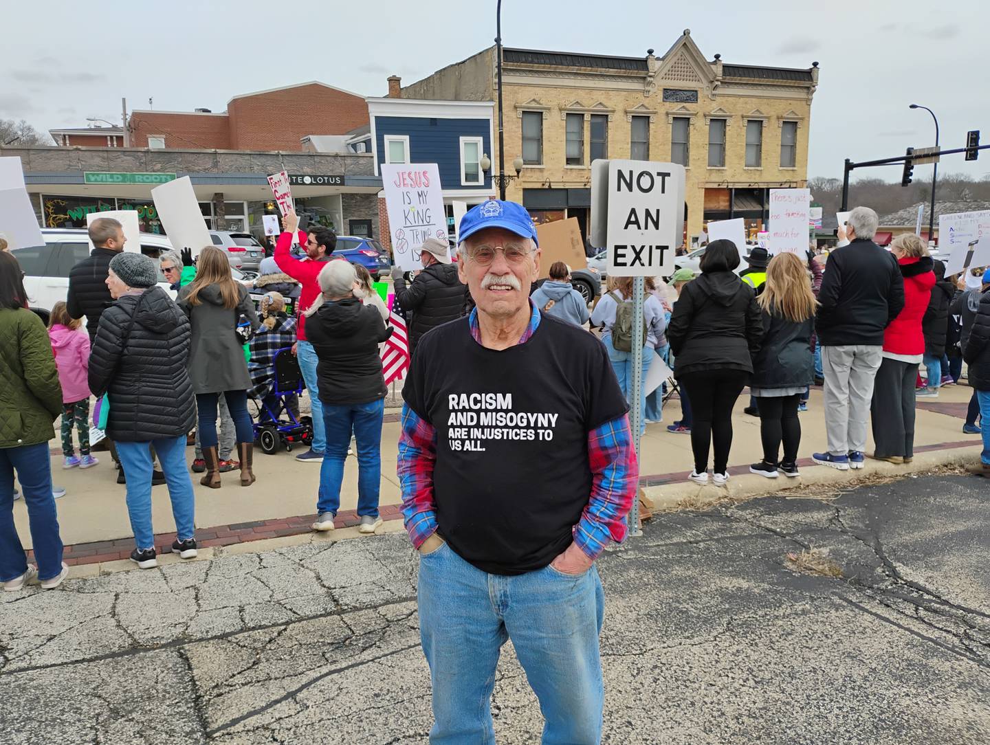 Alex Teipel of St. Charles relied on his T-shirt which stated, 'Racism and misogyny are injustices to us all' instead of a sign at Saturday's Hands Off! National Day of Action in Geneva. 'I am here to protest Trump and all his sycophants who enable him,' Teipel said.