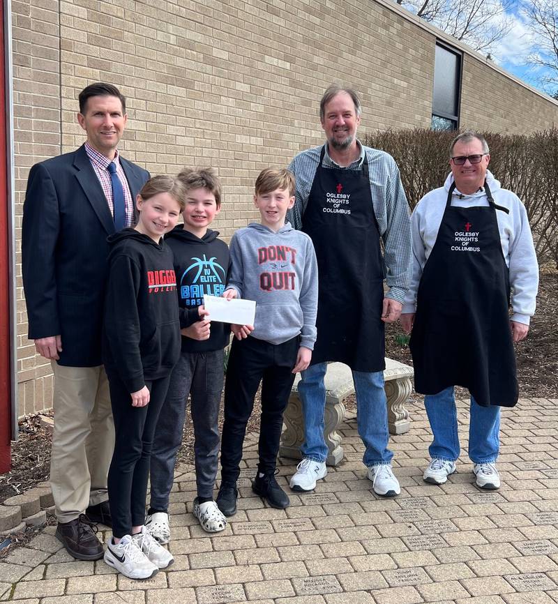 Tom Daley and Ken Stopa, of the Oglesby Knights of Columbus, presented Principal Nathan Boudreau with a check for $1,500 with the proceeds generated from the fish fry.