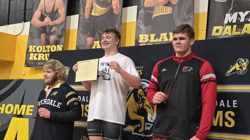 Fulton's Daniel Holman, center, is pictured after winning the 285-pound title at the Riverdale Regional on Saturday, Feb. 8, 2025. Erie-Prophetstown's Caleb Reymer, right, took second and Riverdale's Jake Baustian, left, was third.