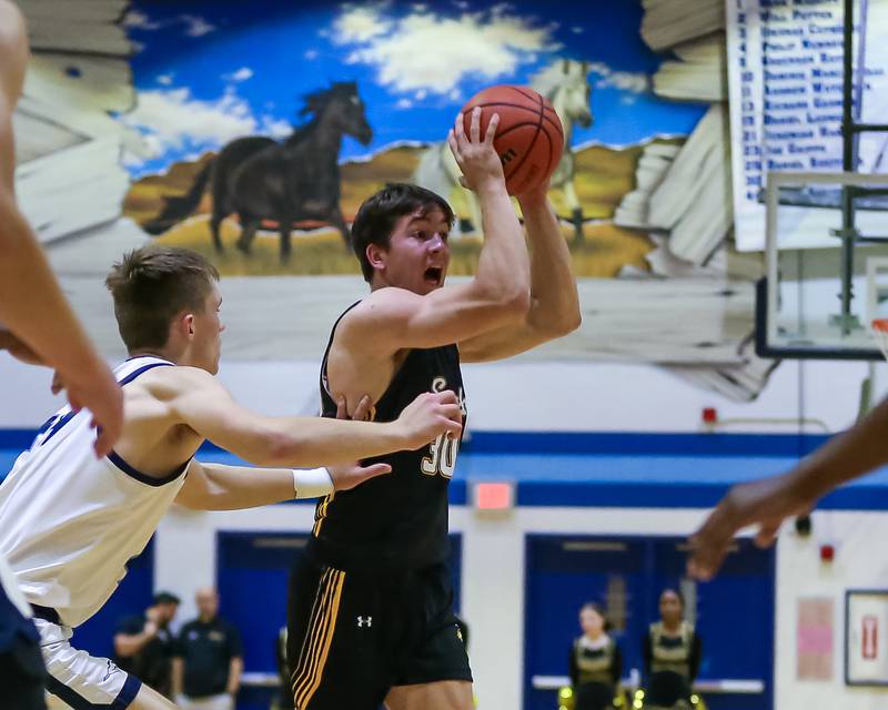 Hinsdale South's Brendan Savage (30) passes to the wing during basketball game between Hinsdale South at Downers Grove South. Dec 1, 2023.