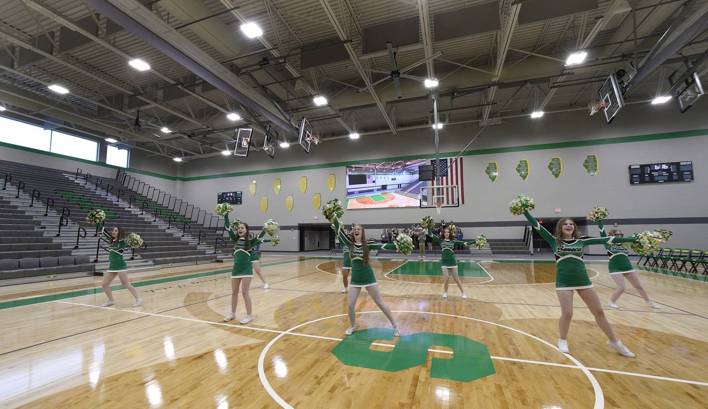 The Seneca High School cheerleaders perform during the open house for the new gymnasium. The gym boasts the largest high school video board in Illinois.