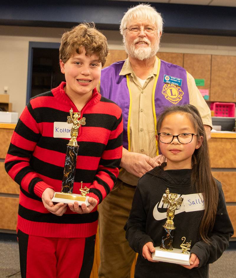(Left to right); Kolton Robinson, Genoa Lions Club President Mike Dreska, and Sally Yang
