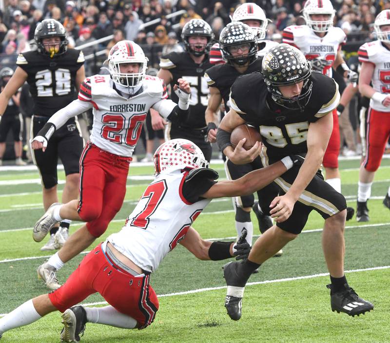 Lena-Winslow's Aiden Wild (85) fights through the arms of Forreston's Jonathan Milnes (27) and into the end zone for a score during 1A playoff action in Lena on Saturday, Nov. 1, 2025.