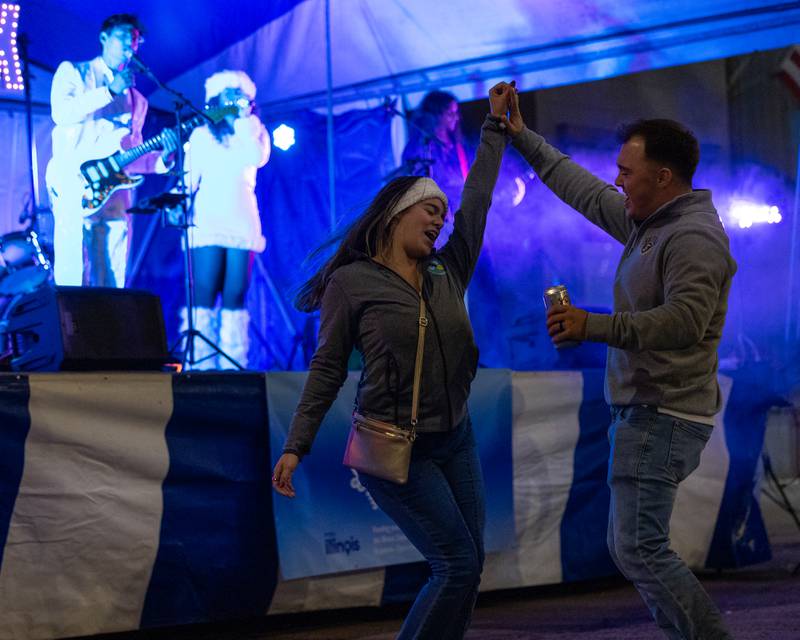 Sophie and Jordan Christopherson dance as Harmonix performs at Frosty on First on Friday, November 7, 2025 on First Street in La Salle.