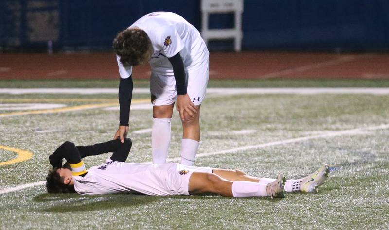 Mendota's Isaac Diaz helps up teammate Johan Cortez after loosing the game against Normal U-High during the Class 1A State semifinal contest on Thursday, Nov. 7, 2024 at Hoffman Estates High School.