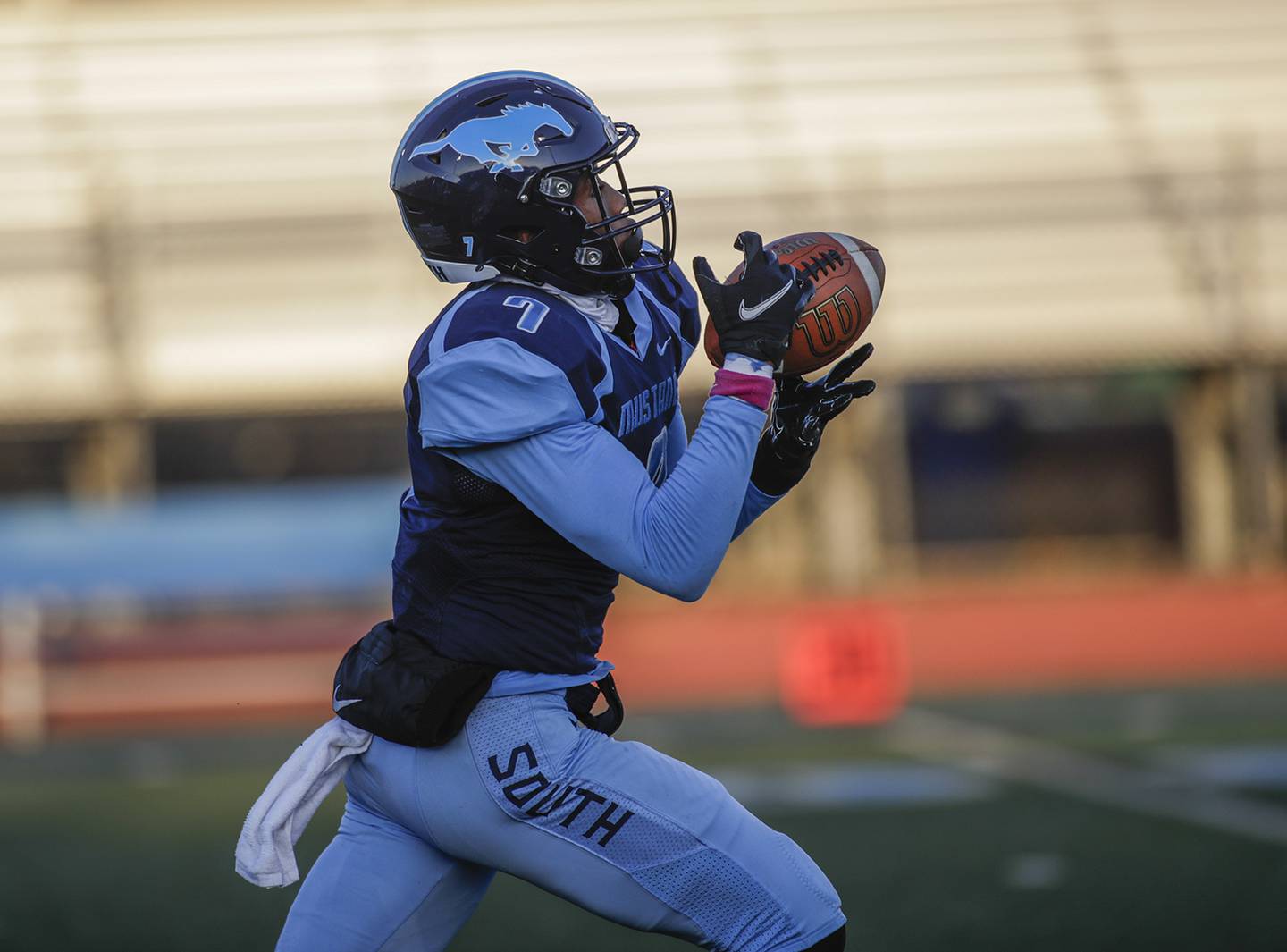 Downers Grove South’s Eli Reed catches a pass before running in for a touchdown against Addison Trail in Downers Grove April 1.